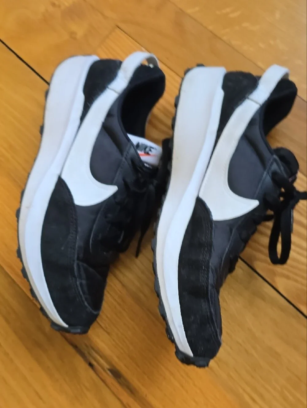 Nike Waffle Debut sneakers featuring a black nylon and suede upper with a white